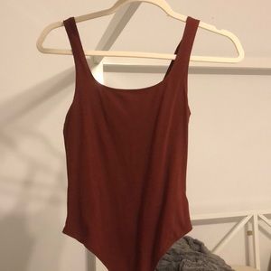 “Fired brick” colored bodysuit from garage